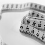 A white tape measure, representing the tracking of progress and goals in weight management